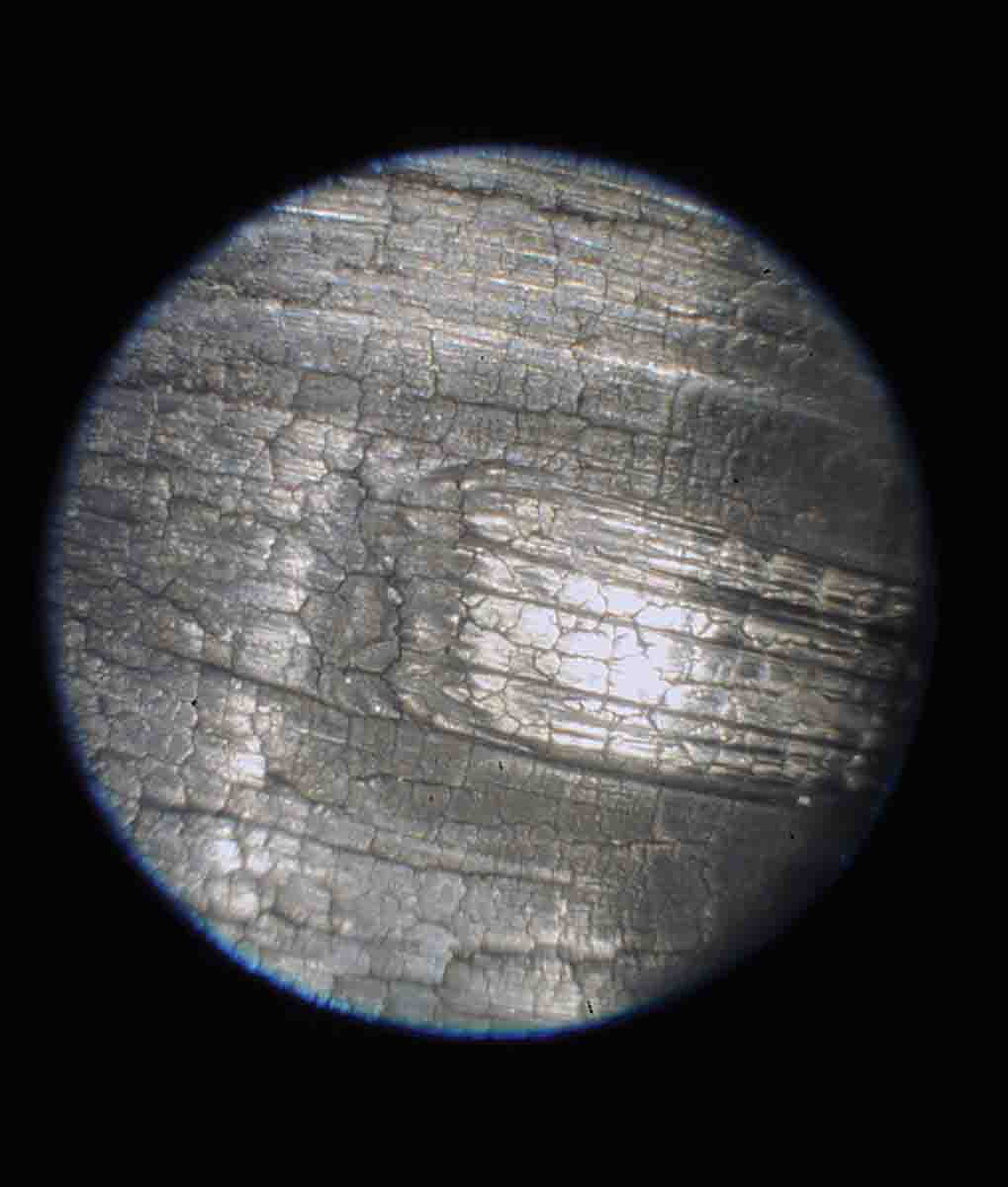 the leade origin in a .264 Winchester Magnum stainless barrel after firing 362 rounds. This leade is washed out and the throat is severely heat cracked. The .264 Winchester has a steeper, 2-degree leade while the WSM has a shallower, 1.5-degree leade.